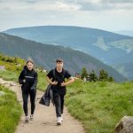 Two people hiking on a mountain trail