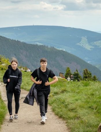 Two people hiking on a mountain trail