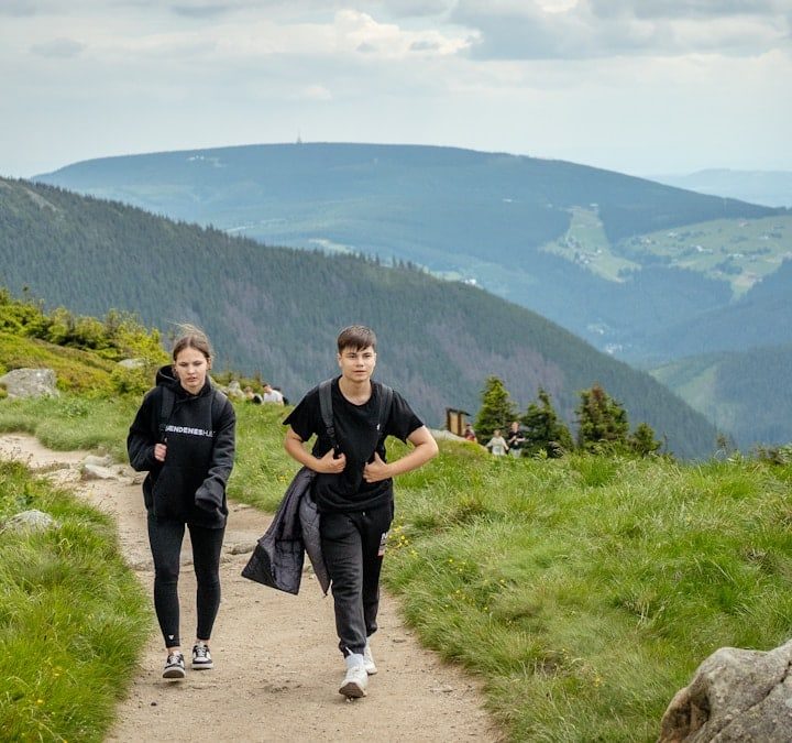 Two people hiking on a mountain trail