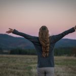 A portrait of a girl from behind just after sunset