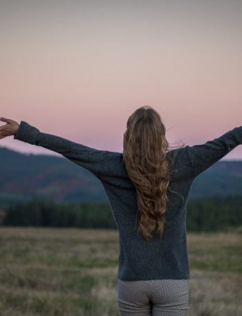 A portrait of a girl from behind just after sunset