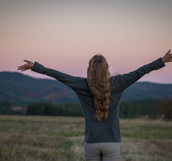 A portrait of a girl from behind just after sunset